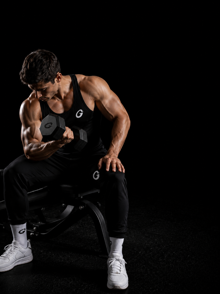 Muscular guy lifting dumbbell